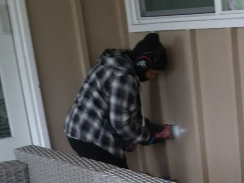 Professional electrician installing an exterior outlet in Monroe