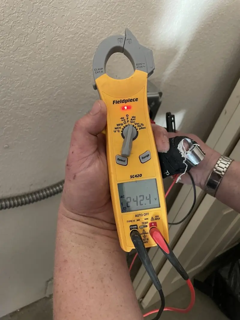 Voltage testing with clamp meter during Electrical Installation Services in Monroe